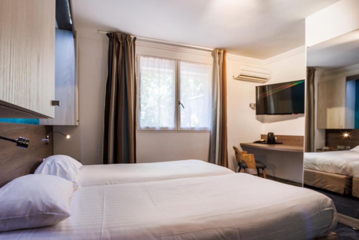 Un ou plusieurs lits dans un hébergement de l'établissement Hotel SPA Plage St Jean
