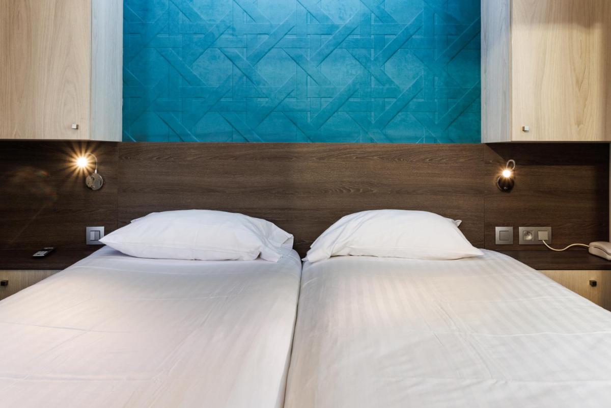 Un ou plusieurs lits dans un hébergement de l'établissement Hotel SPA Plage St Jean