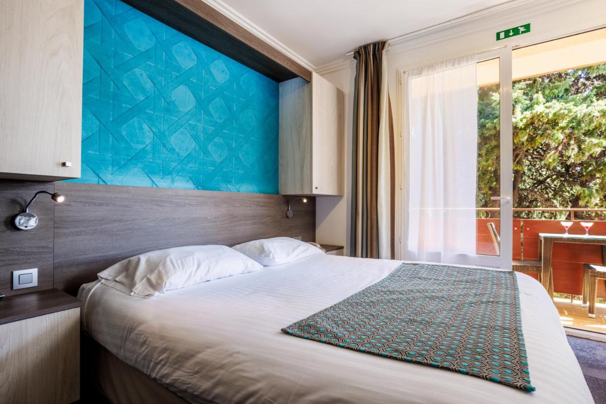 Un ou plusieurs lits dans un hébergement de l'établissement Hotel SPA Plage St Jean