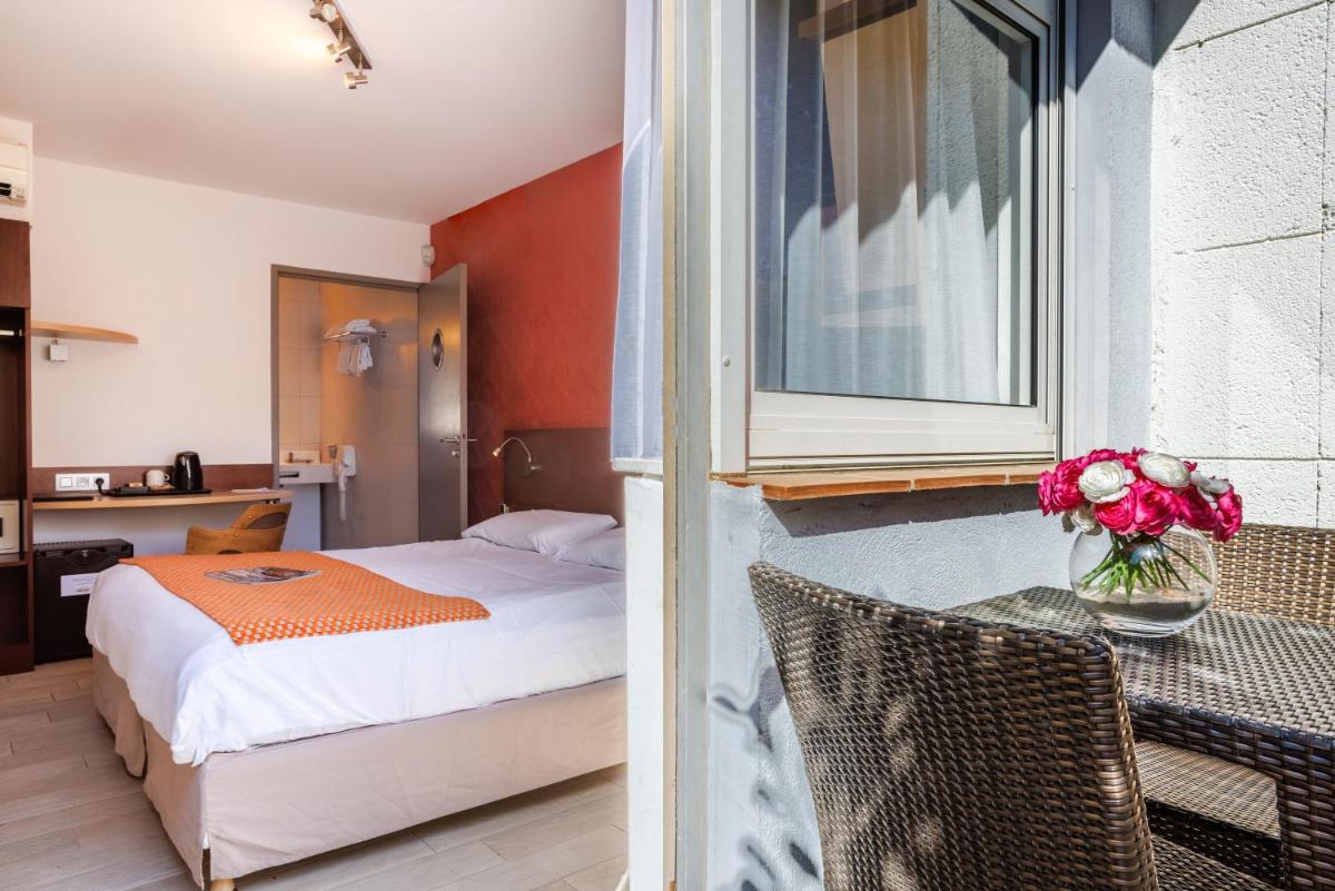 Un ou plusieurs lits dans un hébergement de l'établissement Hotel SPA Plage St Jean