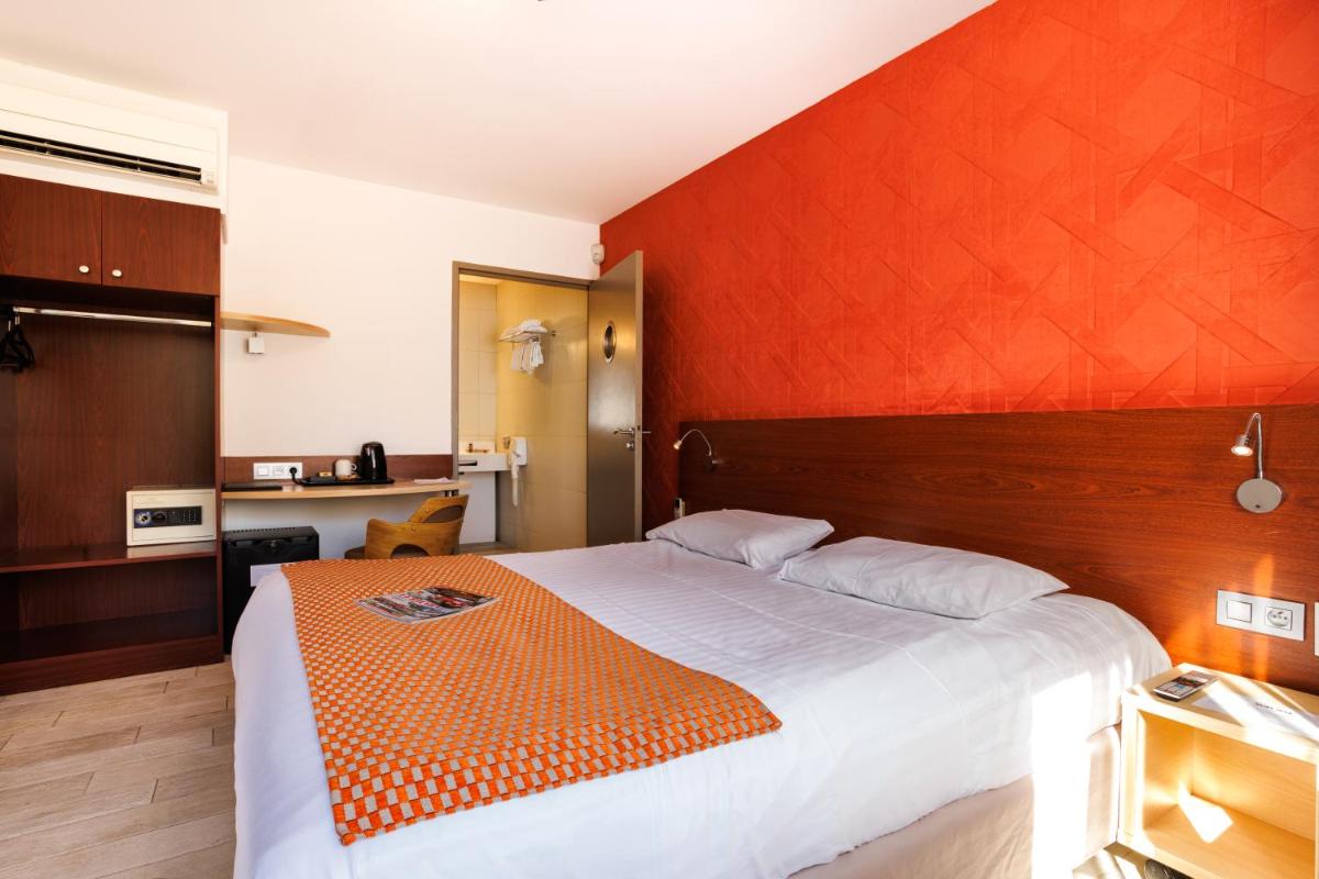 Un ou plusieurs lits dans un hébergement de l'établissement Hotel SPA Plage St Jean