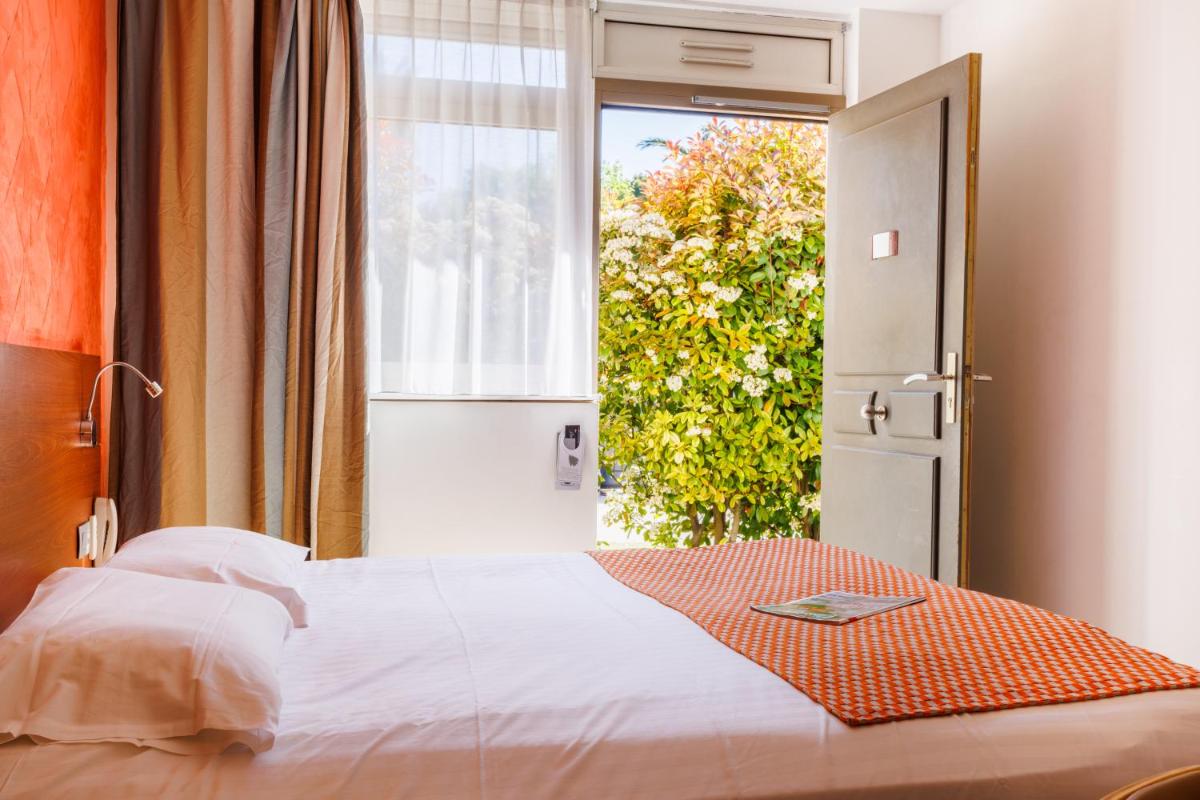 Un ou plusieurs lits dans un hébergement de l'établissement Hotel SPA Plage St Jean