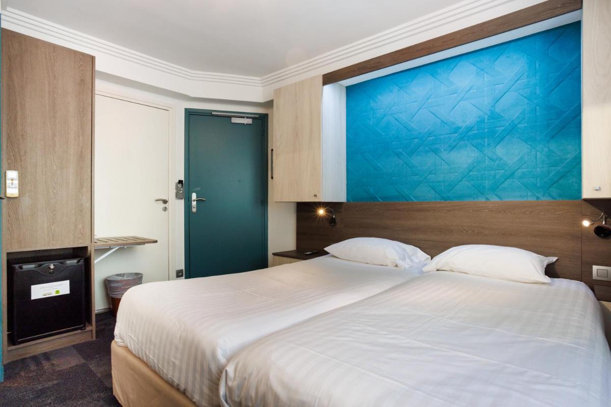 Un ou plusieurs lits dans un hébergement de l'établissement Hotel SPA Plage St Jean