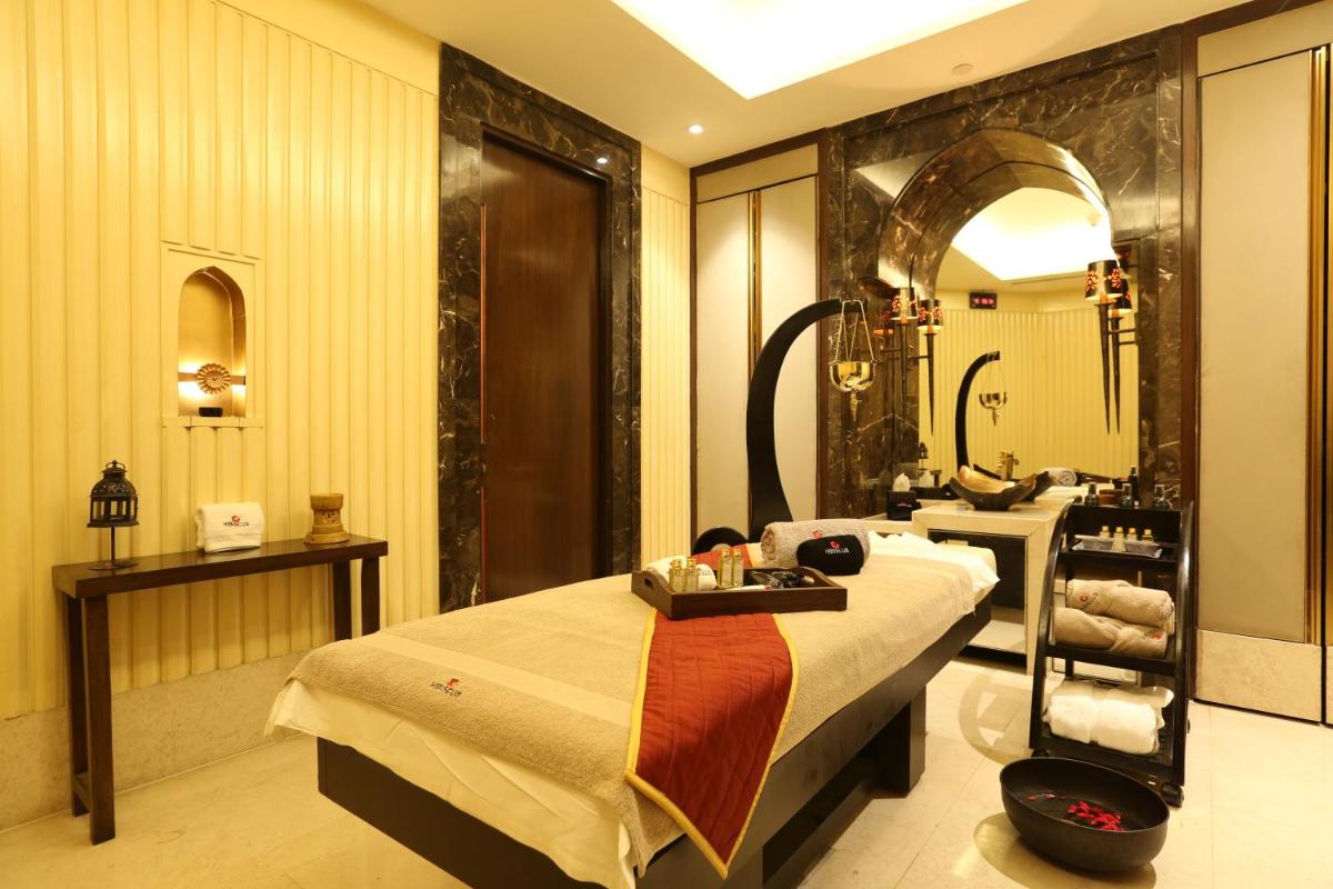 a hotel room with a bed and a bathroom at Crowne Plaza New Delhi Mayur Vihar Noida by IHG in New Delhi