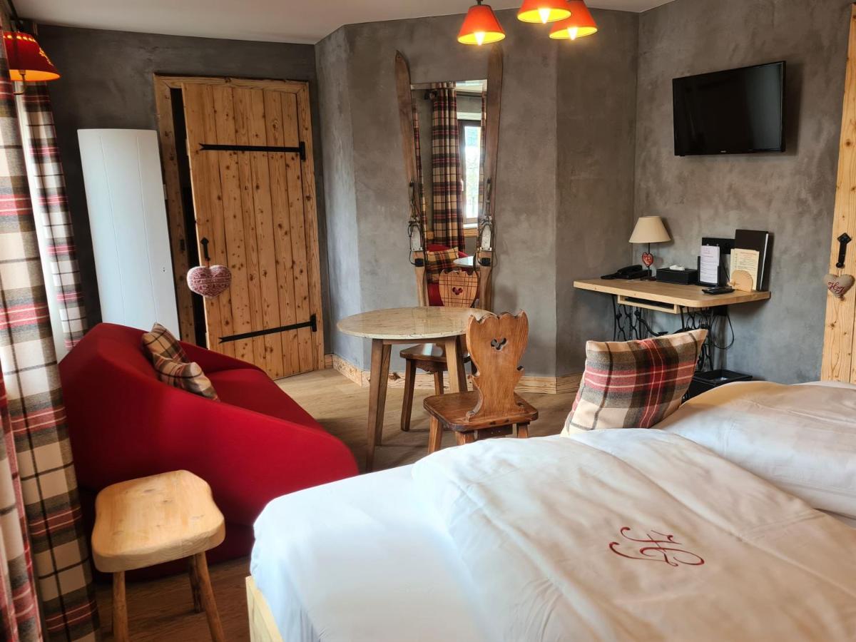 Un ou plusieurs lits dans un hébergement de l'établissement Domaine du Haut Jardin Hôtel & Chalets Spa Privé