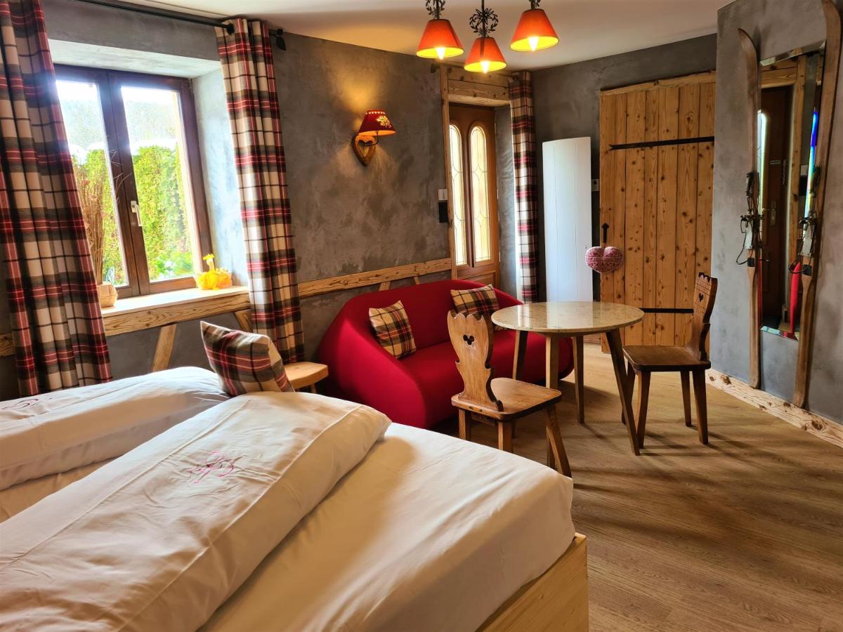 Un ou plusieurs lits dans un hébergement de l'établissement Domaine du Haut Jardin Hôtel & Chalets Spa Privé