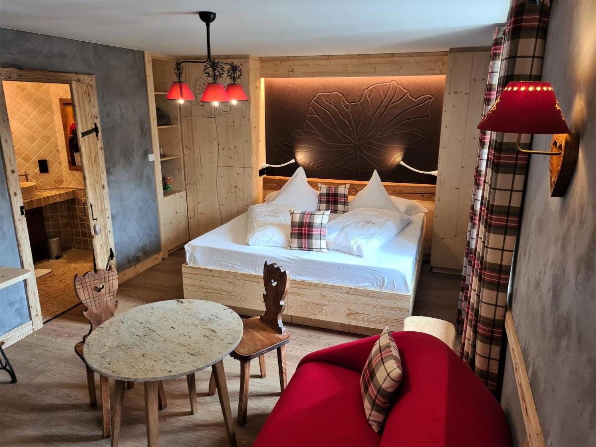 Un ou plusieurs lits dans un hébergement de l'établissement Domaine du Haut Jardin Hôtel & Chalets Spa Privé