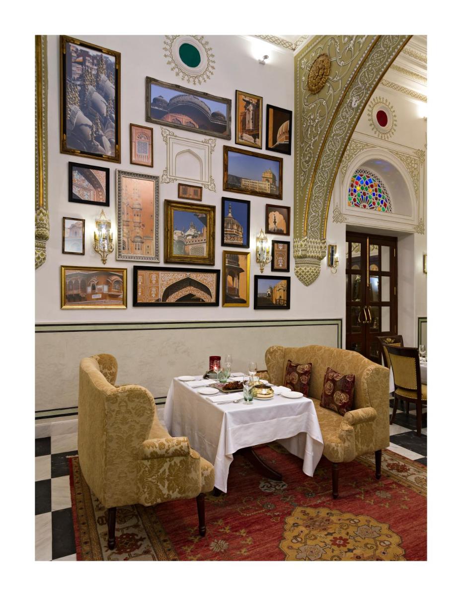 a dining room with a table and two chairs at Samode Haveli in Jaipur