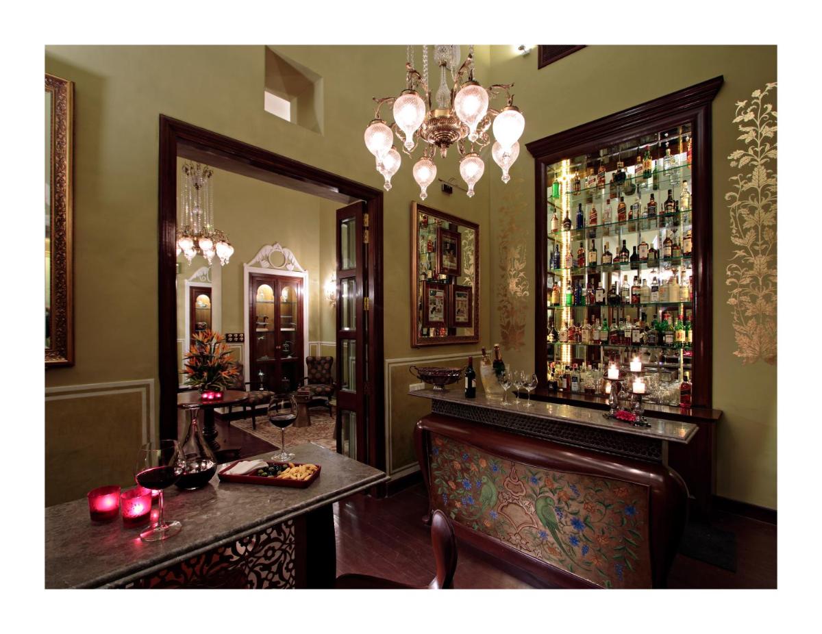 a bar in a restaurant with a chandelier at Samode Haveli in Jaipur
