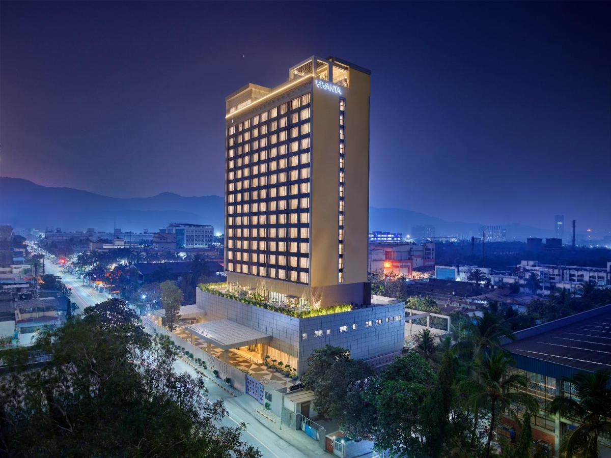 a tall building in a city at night at Vivanta Navi Mumbai Turbhe in Navi Mumbai