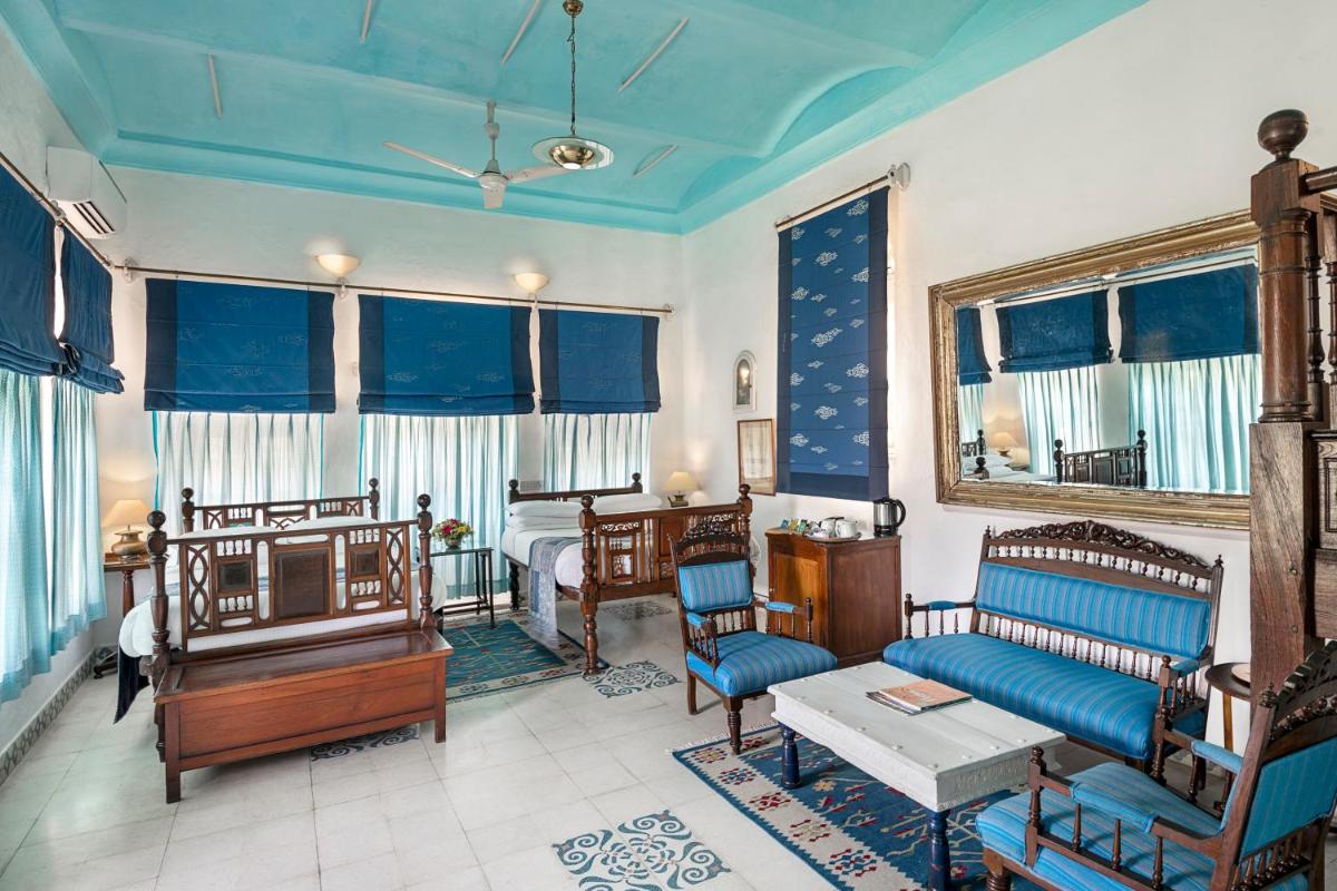 a living room with a couch and a bed at Neemrana Fort-Palace in Neemrana