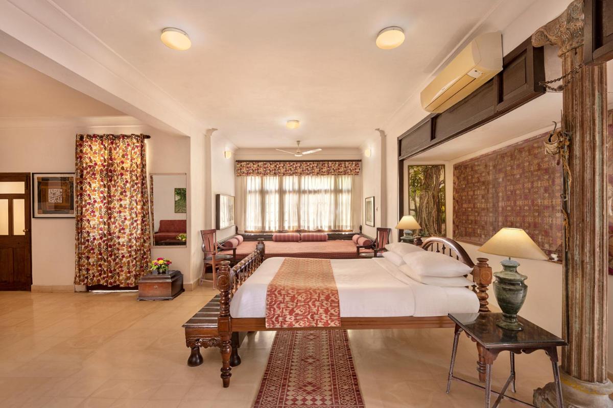 a bedroom with a bed and a living room at Neemrana Fort-Palace in Neemrana