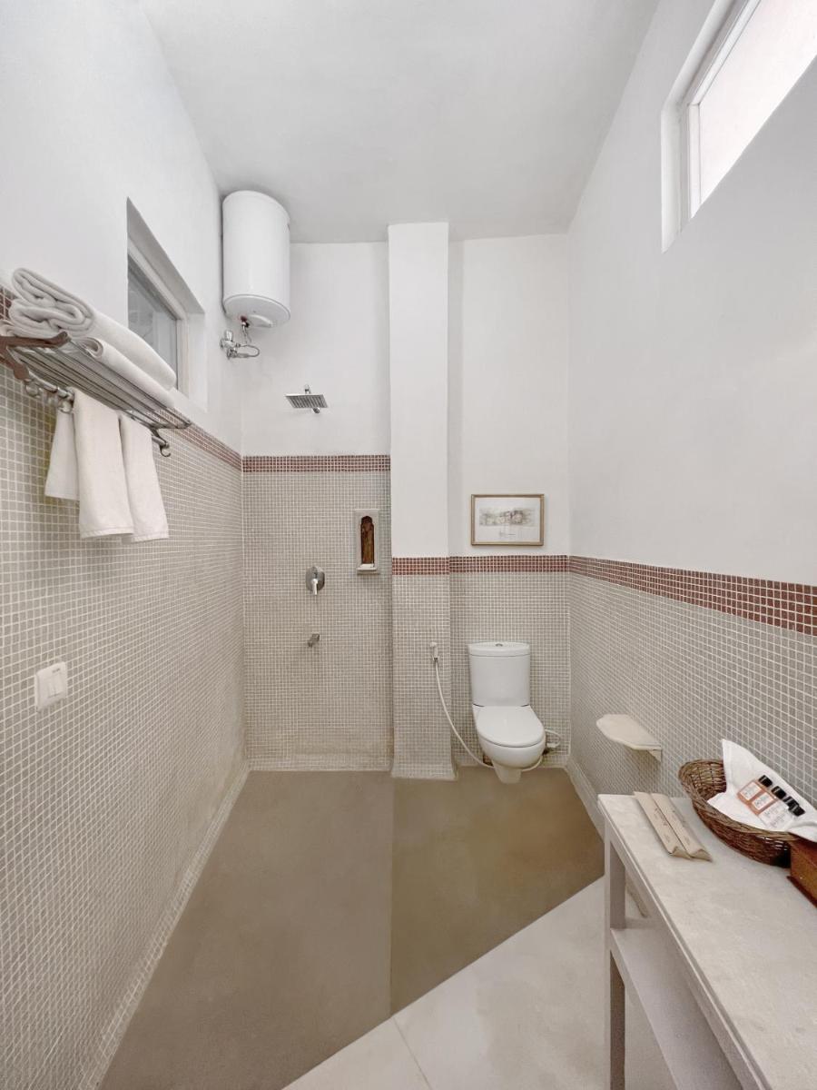 a bathroom with a toilet and a sink at Neemrana Fort-Palace in Neemrana