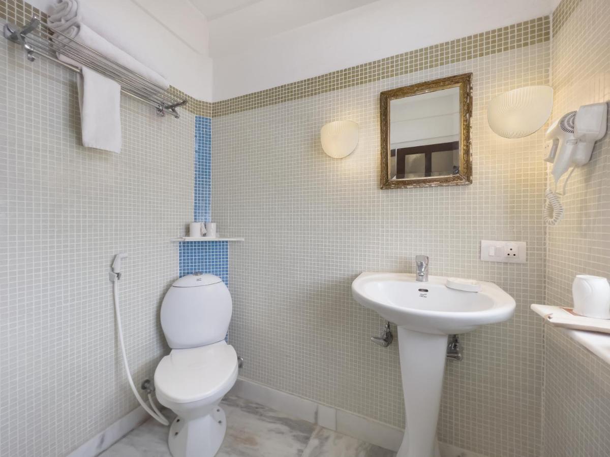 a bathroom with a toilet and a sink at Neemrana Fort-Palace in Neemrana