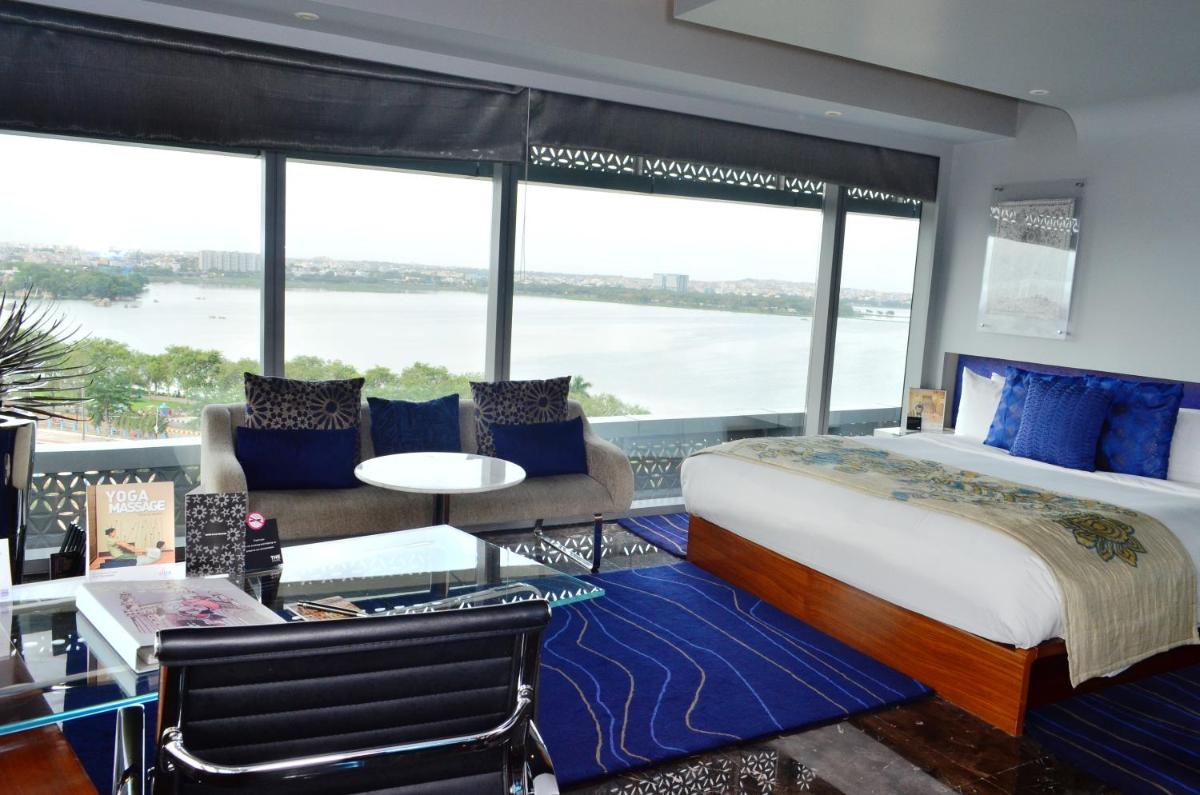 a bedroom with a large bed and a large window at The Park Hyderabad, Banjara Hills near Hussain Sagar Lake in Hyderabad a bedroom with a large bed and a large window at The Park Hyderabad, Banjara Hills near Hussain Sagar Lake in Hyderabad