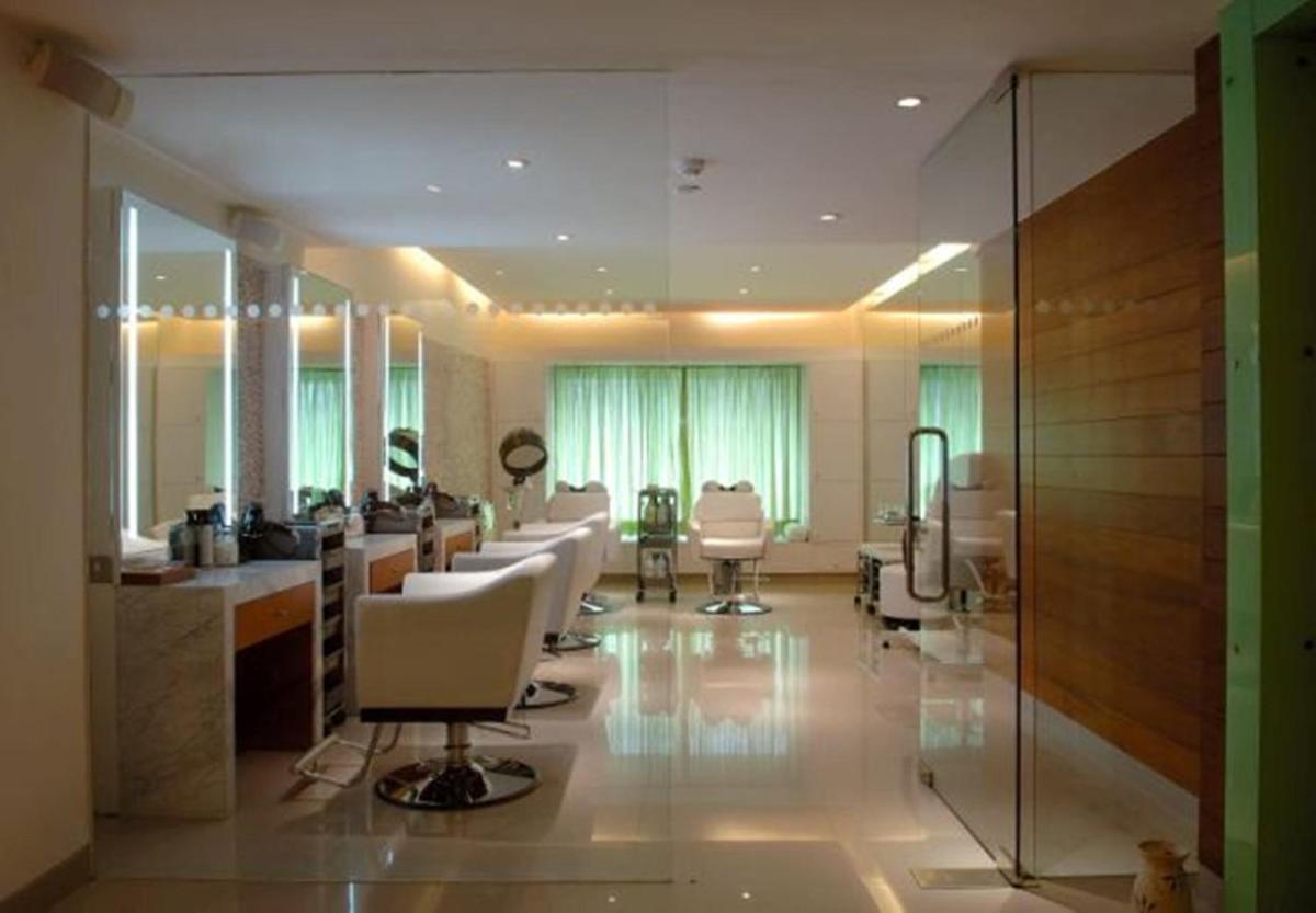 a salon with white chairs and a barber shop at The Park New Delhi in New Delhi a salon with white chairs and a barber shop at The Park New Delhi in New Delhi