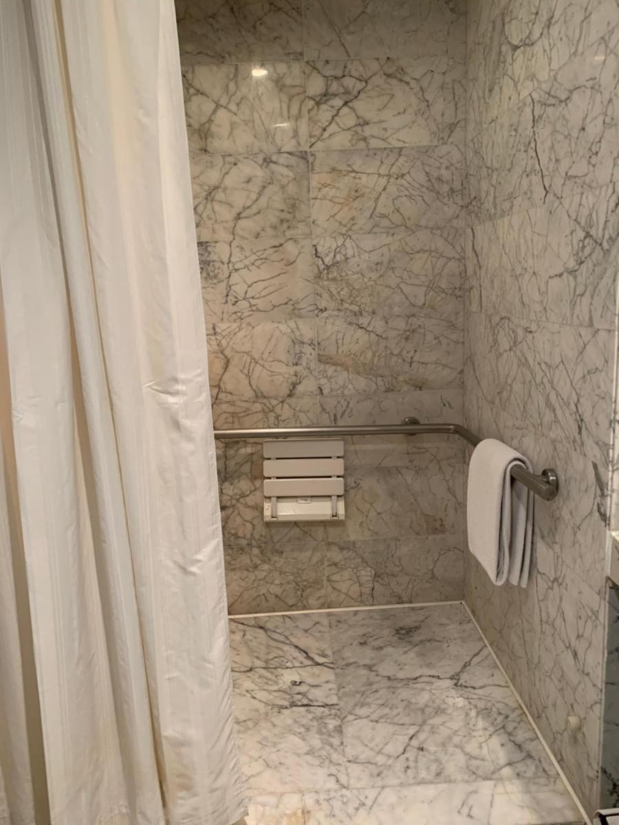 a bathroom with a shower with a shower curtain at InterContinental Marine Drive Mumbai by IHG in Mumbai