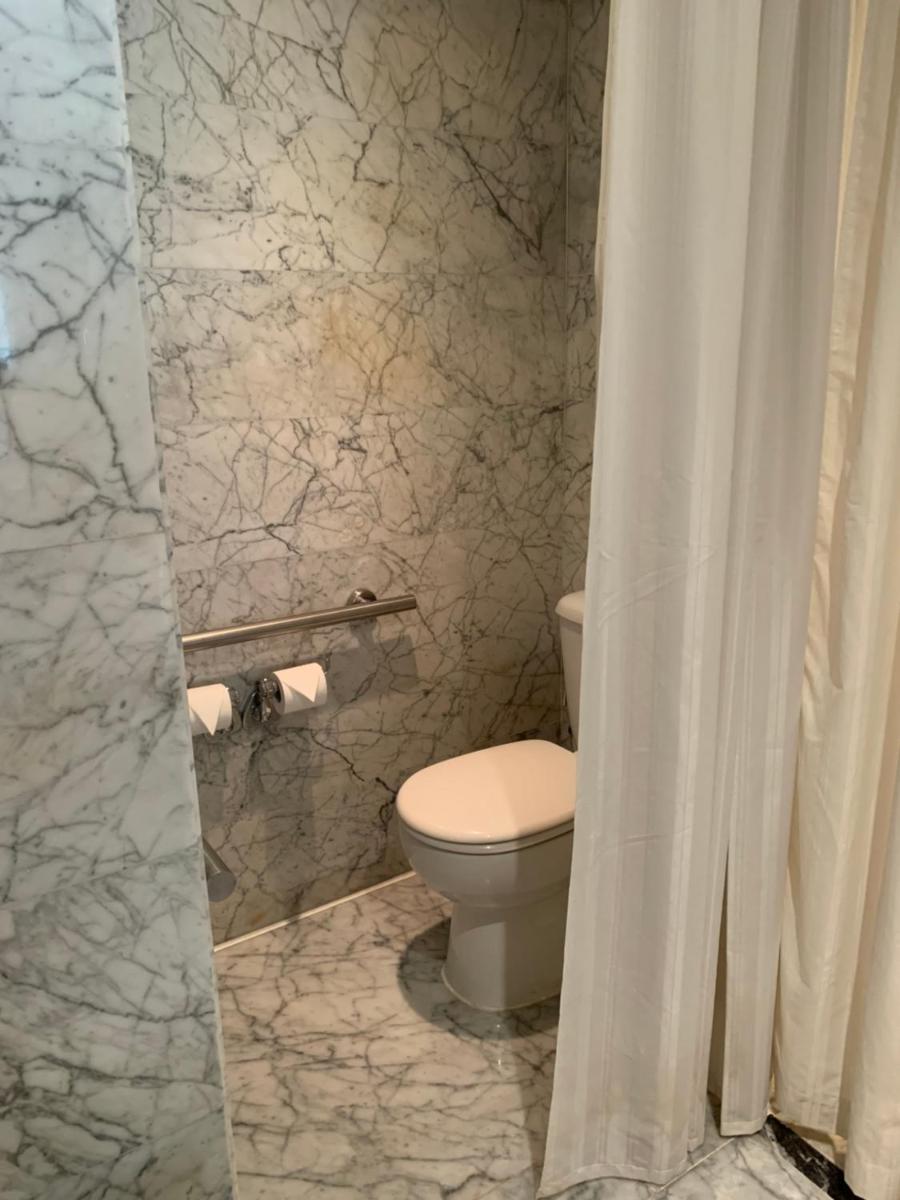 a bathroom with a toilet and a shower curtain at InterContinental Marine Drive Mumbai by IHG in Mumbai