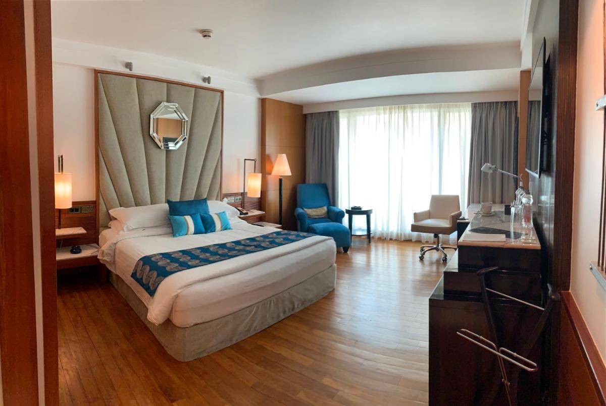 a hotel room with a bed and a desk at InterContinental Marine Drive Mumbai by IHG in Mumbai