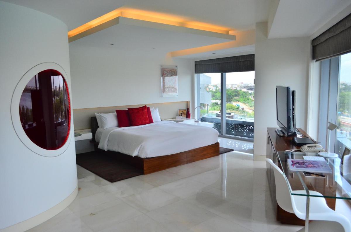 a bedroom with a bed and a tv in a room at The Park Hyderabad, Banjara Hills near Hussain Sagar Lake in Hyderabad a bedroom with a bed and a tv in a room at The Park Hyderabad, Banjara Hills near Hussain Sagar Lake in Hyderabad