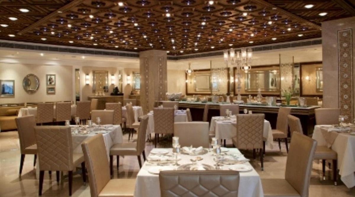 a dining room with white tables and chairs at The Park Hyderabad, Banjara Hills near Hussain Sagar Lake in Hyderabad a dining room with white tables and chairs at The Park Hyderabad, Banjara Hills near Hussain Sagar Lake in Hyderabad