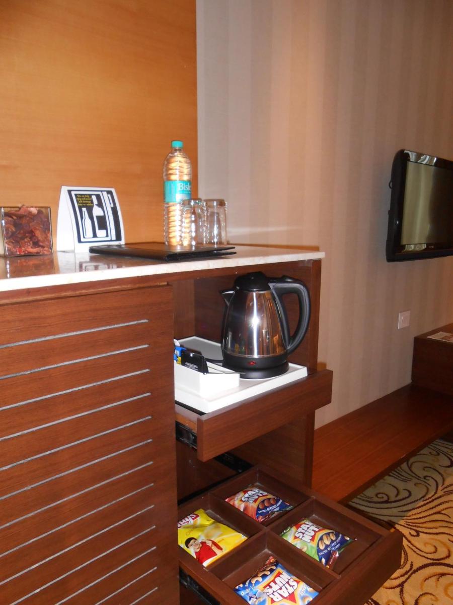 a hotel room with a tea kettle on a counter at Pride Plaza Hotel, Kolkata in Kolkata