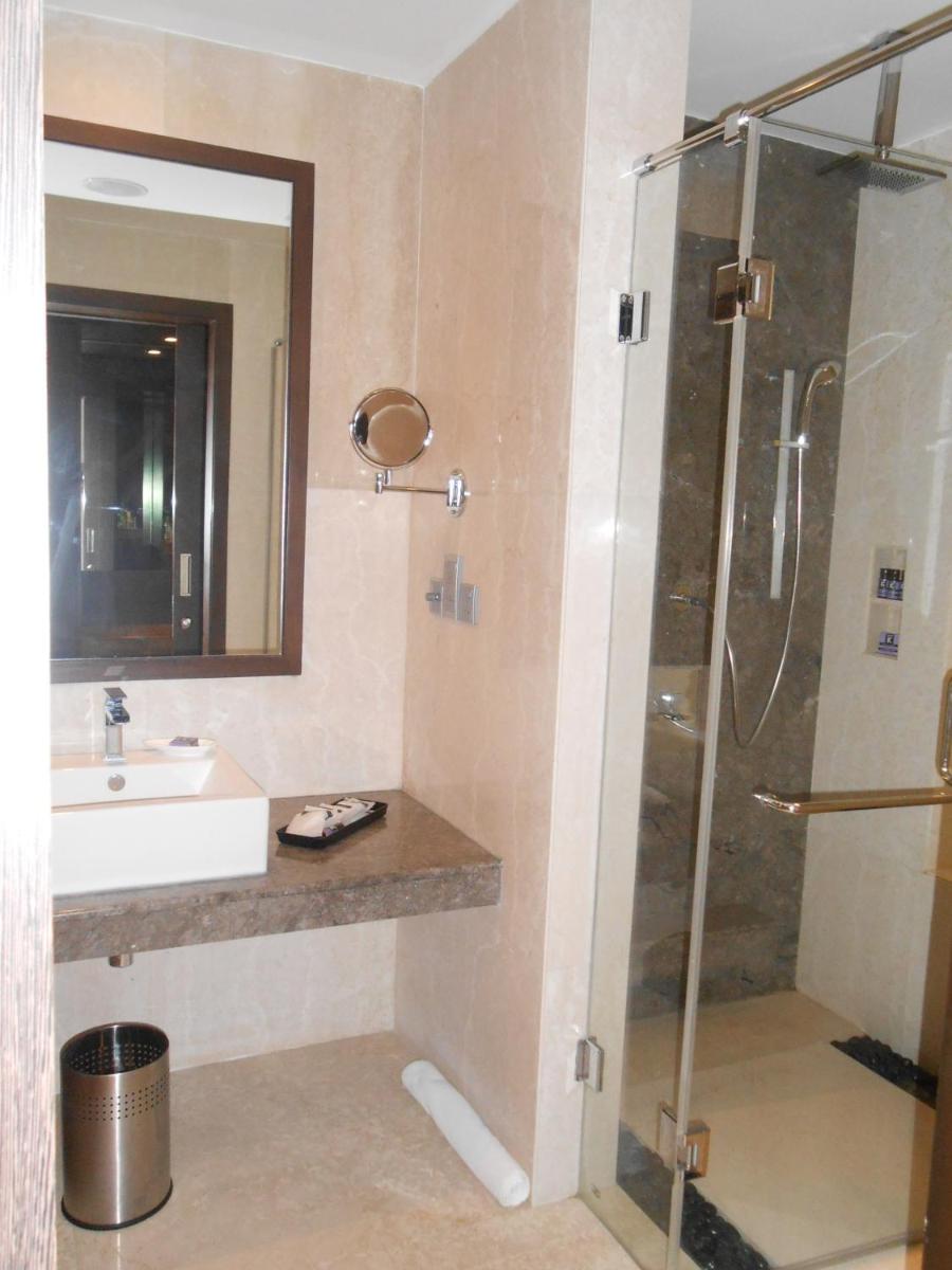 a bathroom with a shower and a sink at The Lalit Great Eastern Kolkata in Kolkata a bathroom with a shower and a sink at The Lalit Great Eastern Kolkata in Kolkata