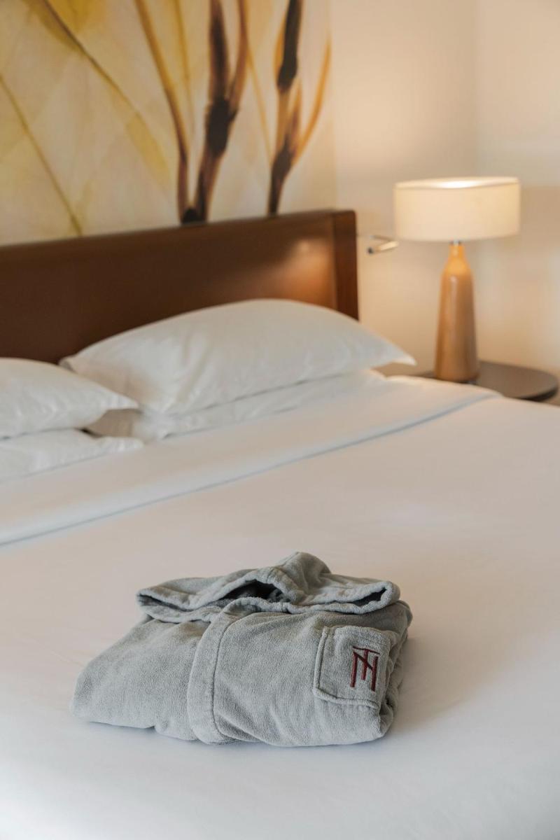 Uma cama ou camas num quarto em Terra Nostra Garden Hotel