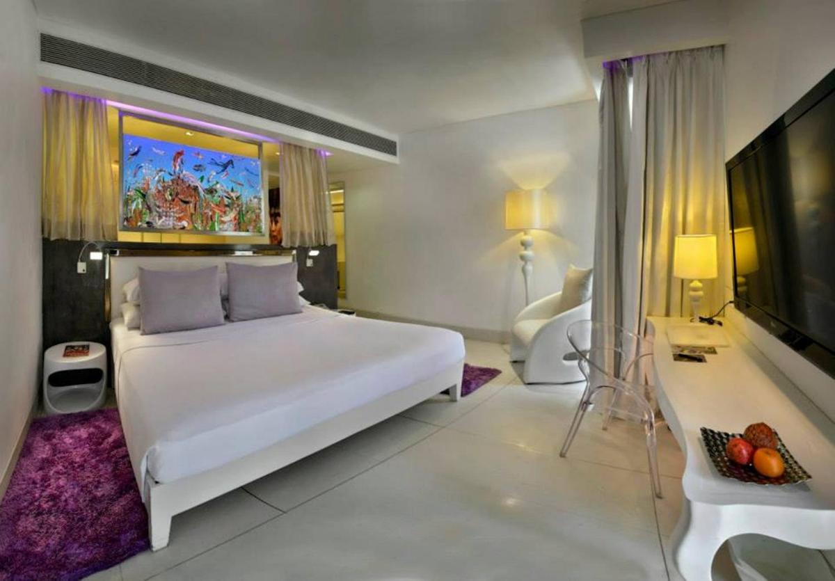 a bedroom with a large white bed and a television at The Park Calangute Goa in Calangute a bedroom with a large white bed and a television at The Park Calangute Goa in Calangute