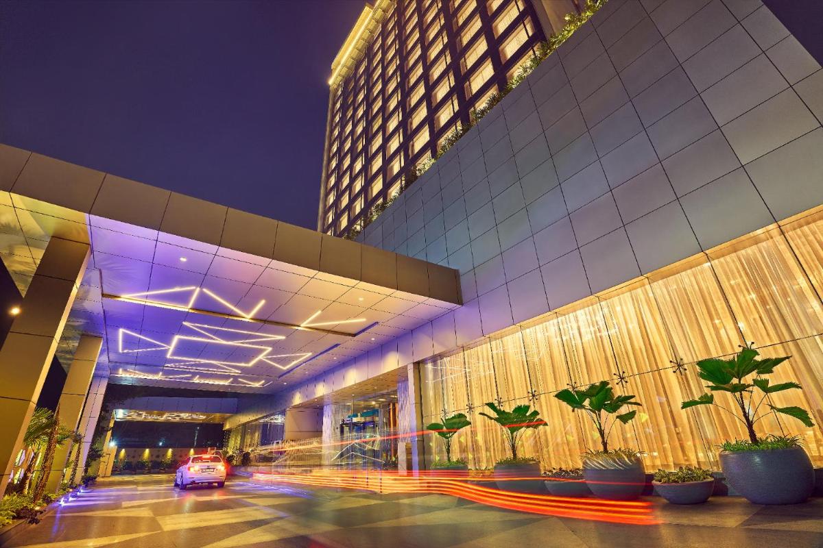 a building with a car parked in front of it at Vivanta Navi Mumbai Turbhe in Navi Mumbai