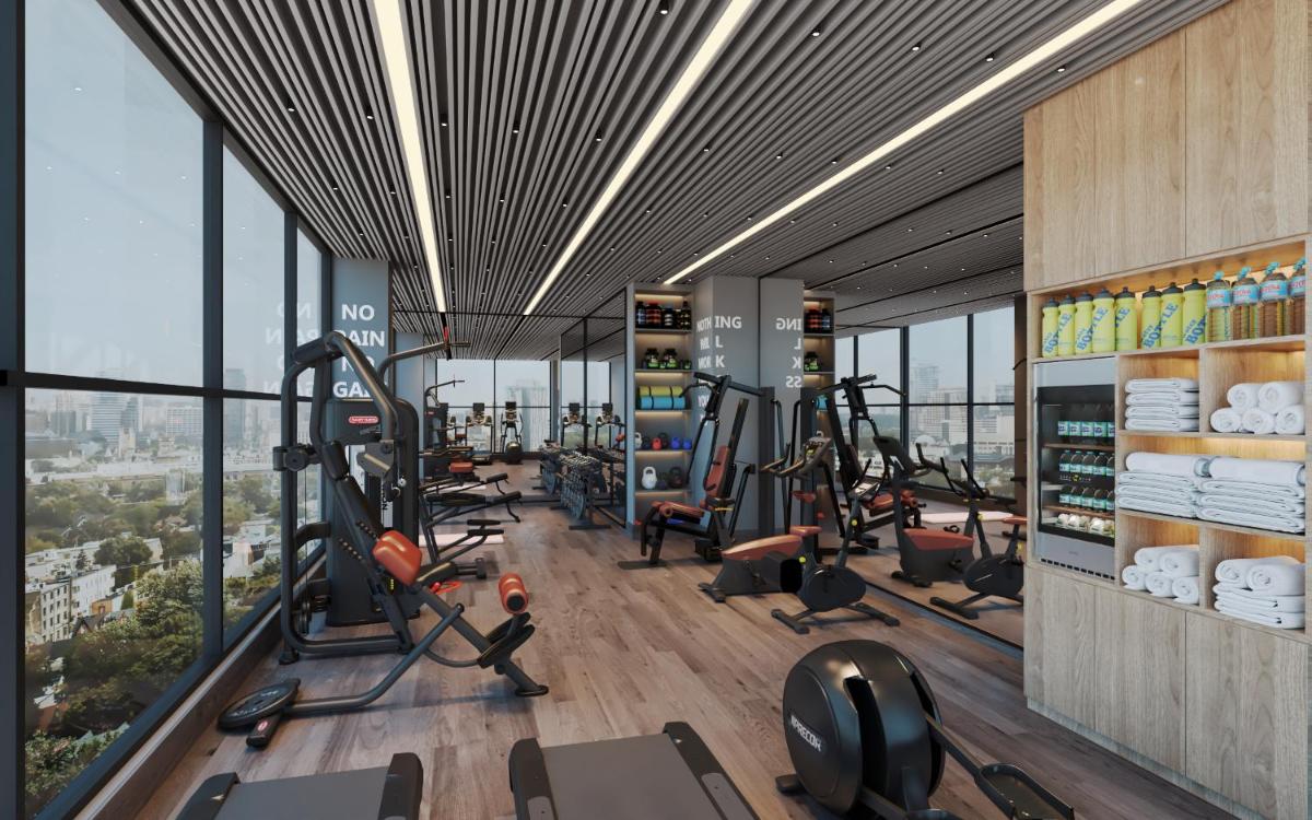 a gym with treadmills and ellipticals in a building at Vivanta Navi Mumbai Turbhe in Navi Mumbai