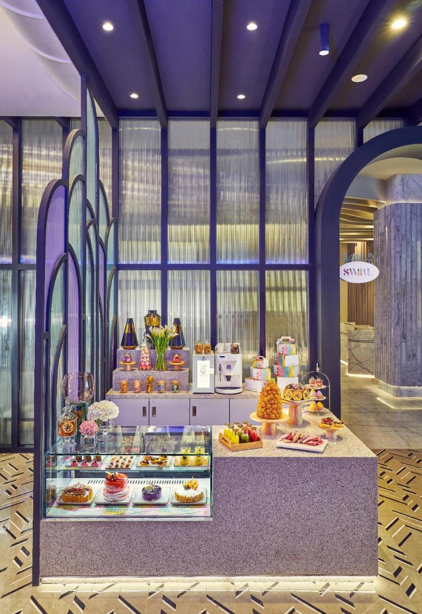 a bakery with many different types of food on display at Vivanta Navi Mumbai Turbhe in Navi Mumbai
