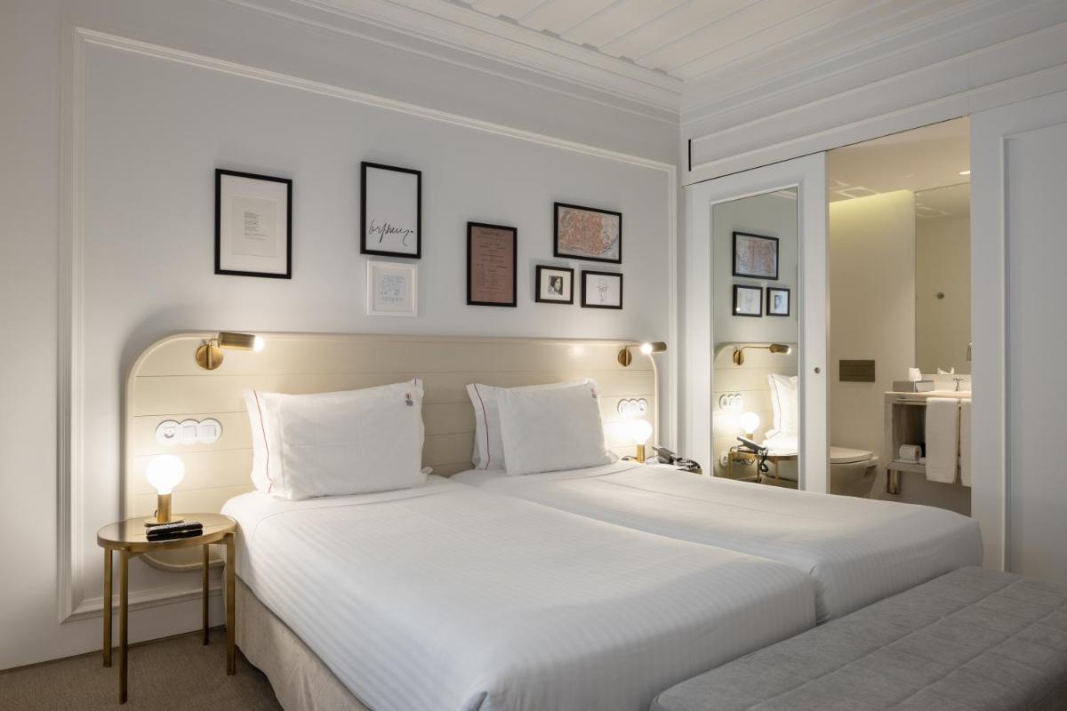 Uma cama ou camas num quarto em Lisboa Pessoa Hotel