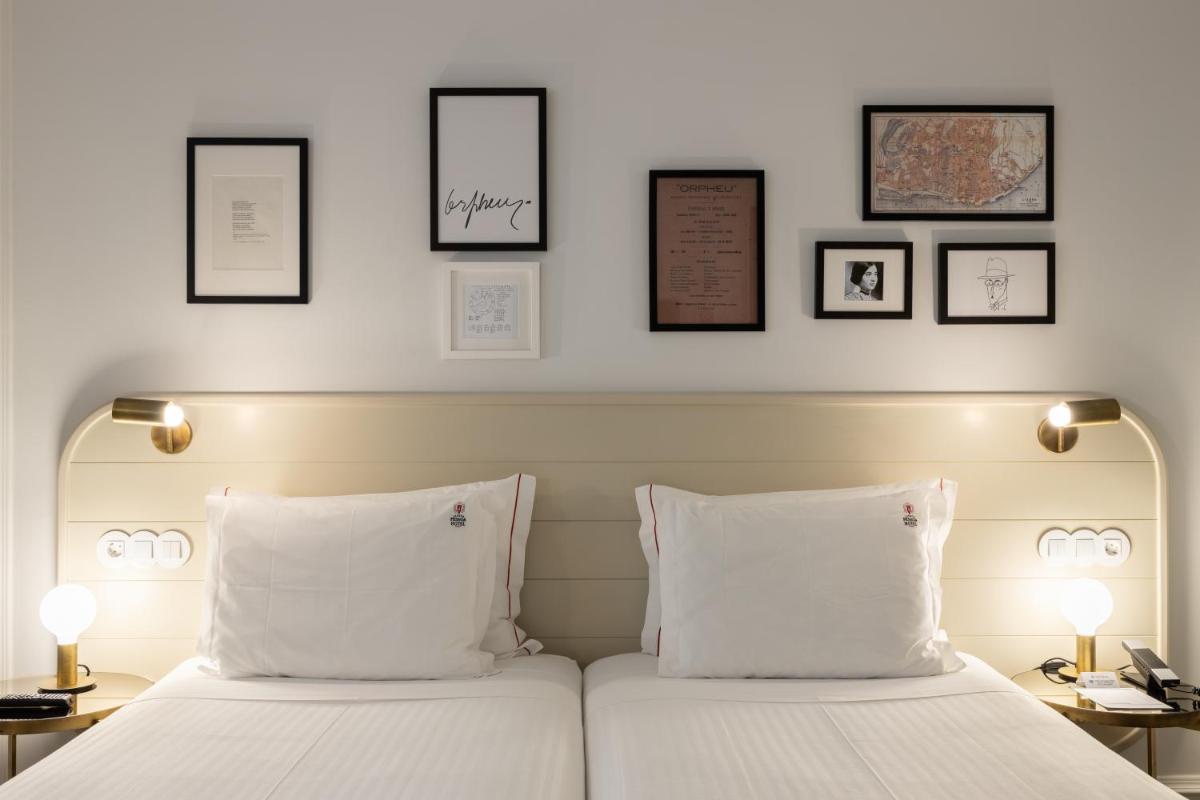 Uma cama ou camas num quarto em Lisboa Pessoa Hotel