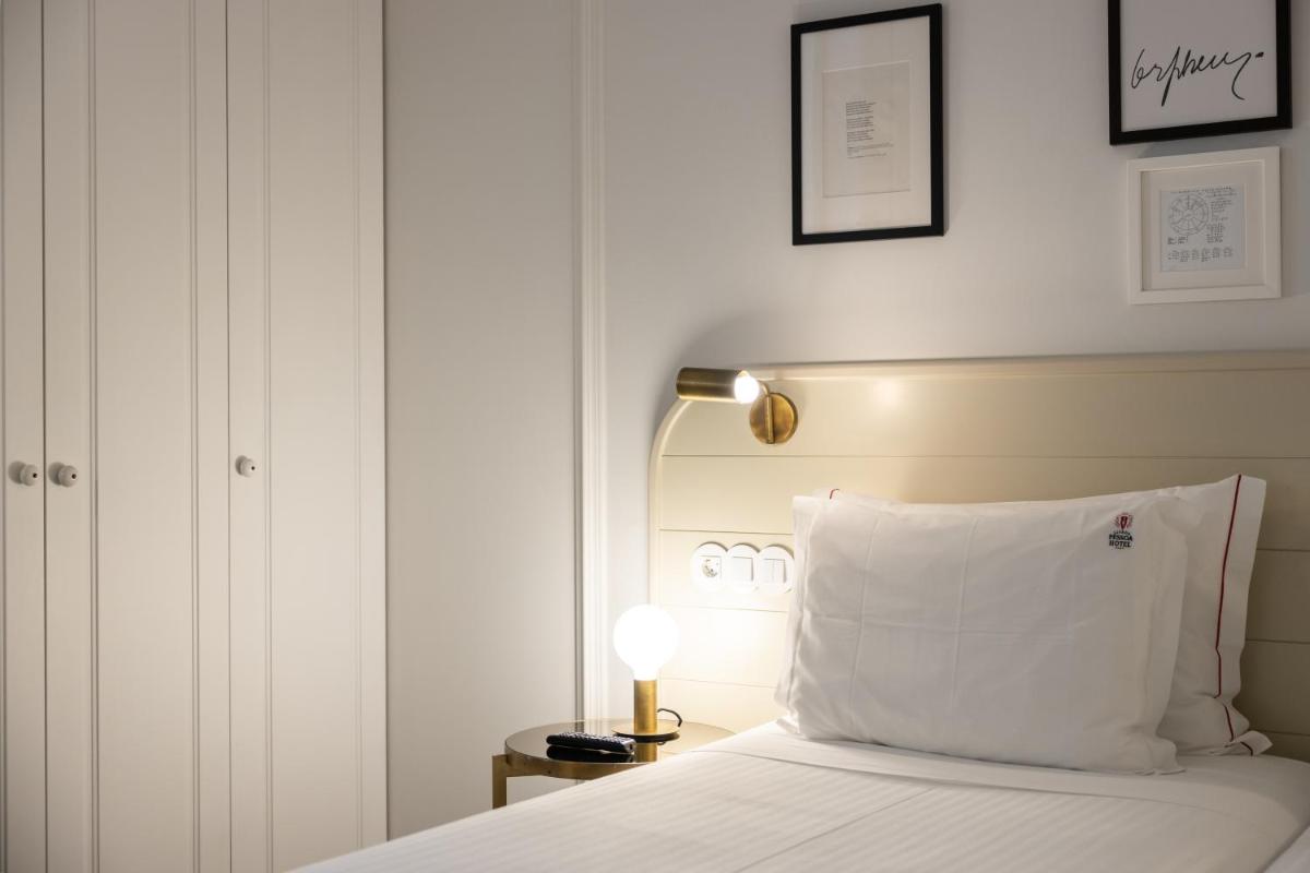 Uma cama ou camas num quarto em Lisboa Pessoa Hotel