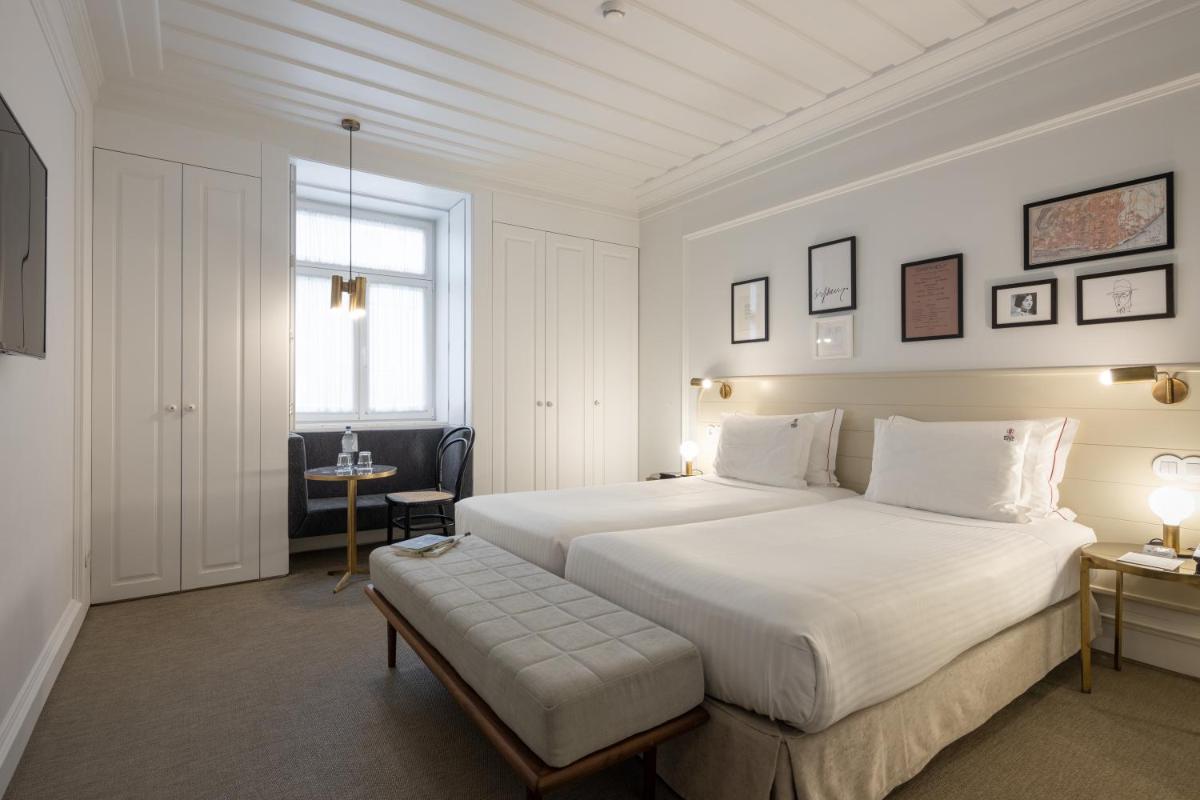 Uma cama ou camas num quarto em Lisboa Pessoa Hotel