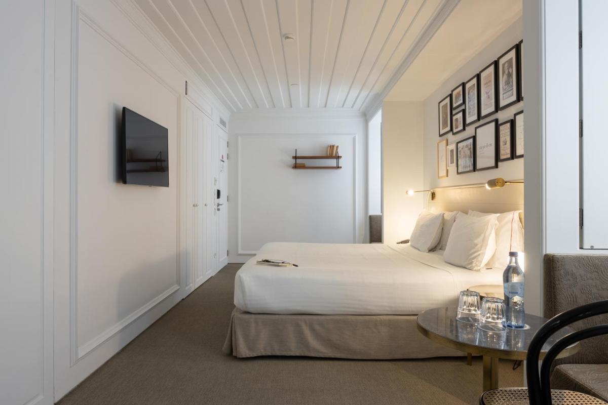 Uma cama ou camas num quarto em Lisboa Pessoa Hotel