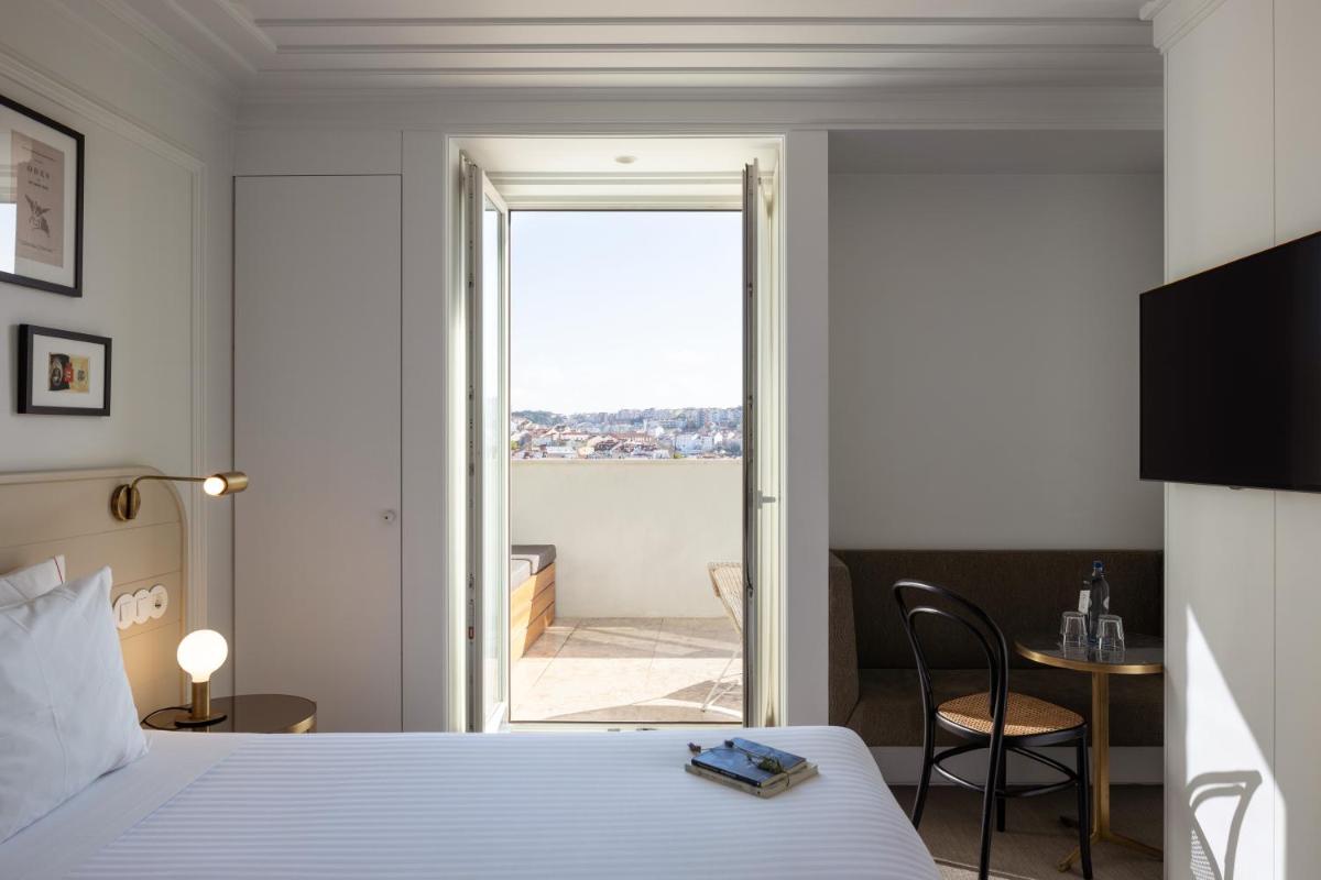Uma cama ou camas num quarto em Lisboa Pessoa Hotel