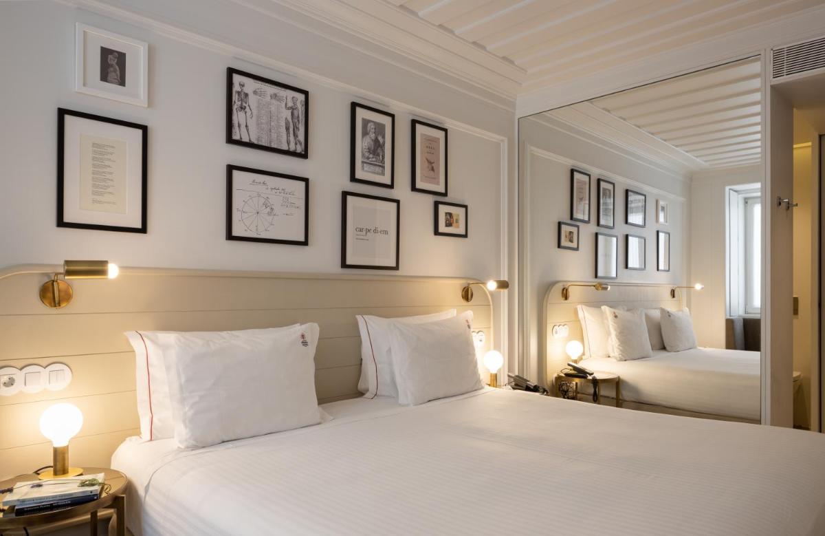 Uma cama ou camas num quarto em Lisboa Pessoa Hotel