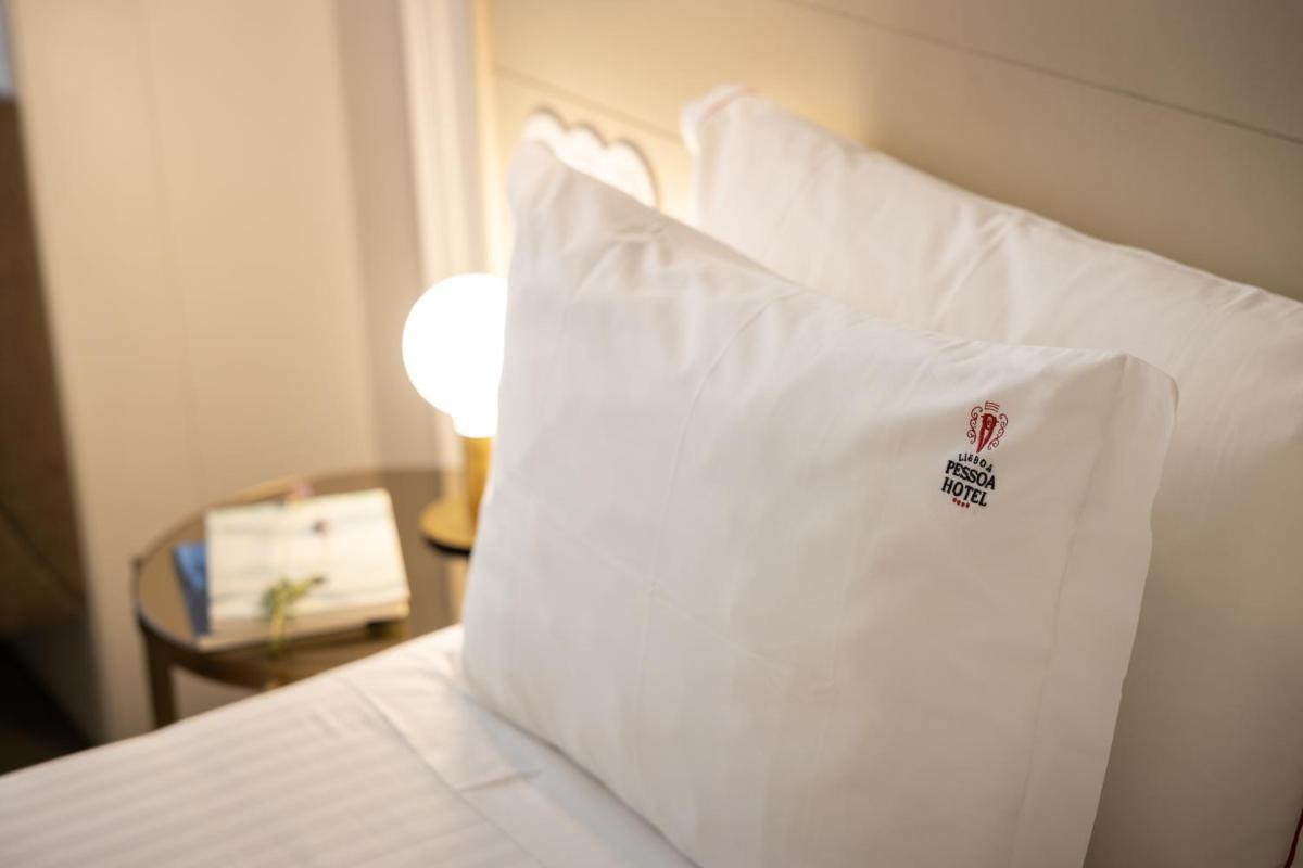 Uma cama ou camas num quarto em Lisboa Pessoa Hotel