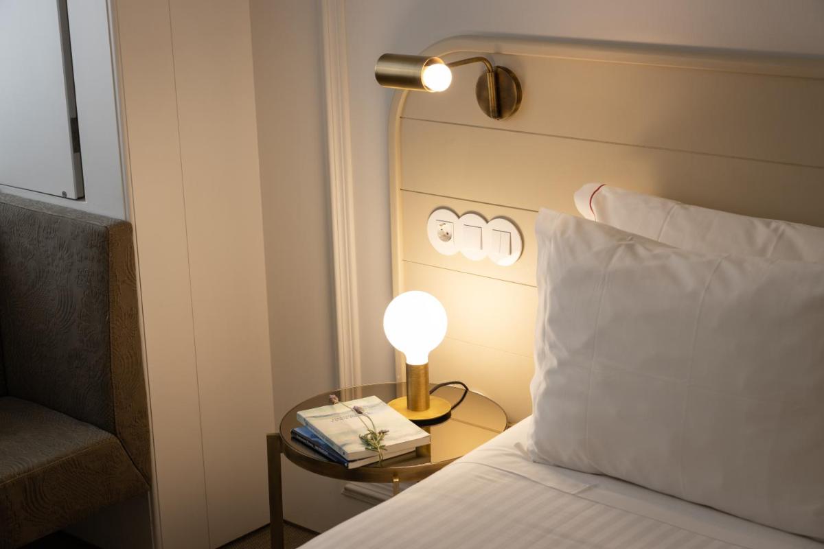 Uma cama ou camas num quarto em Lisboa Pessoa Hotel