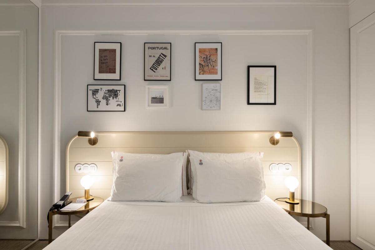 Uma cama ou camas num quarto em Lisboa Pessoa Hotel