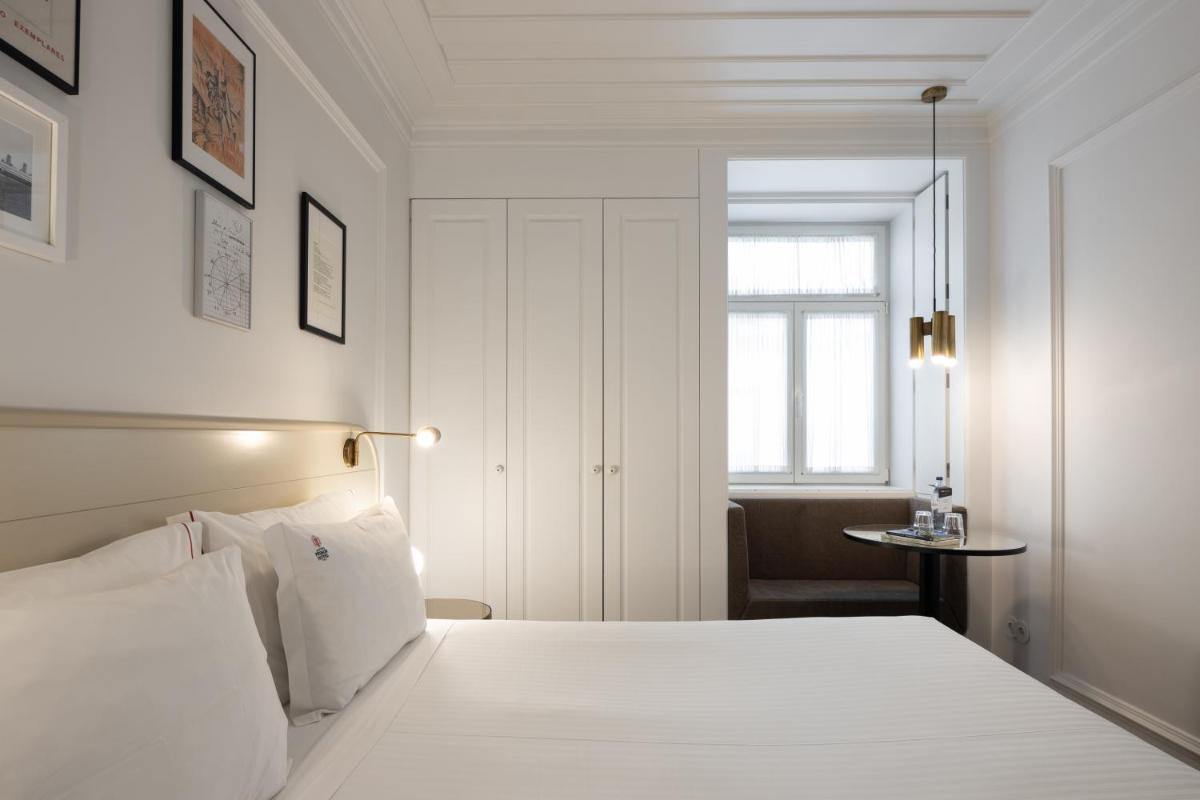 Uma cama ou camas num quarto em Lisboa Pessoa Hotel