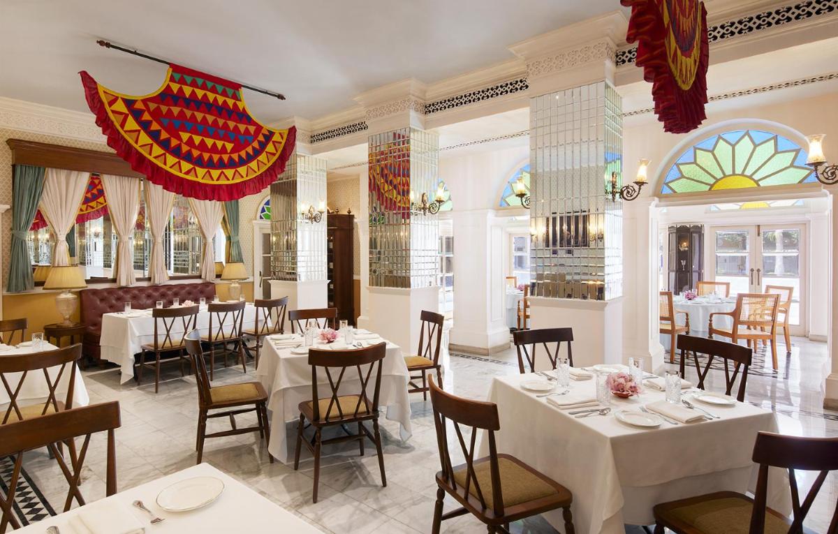 a restaurant with tables and chairs in a room at Raajkutir - IHCL SeleQtions in Kolkata
