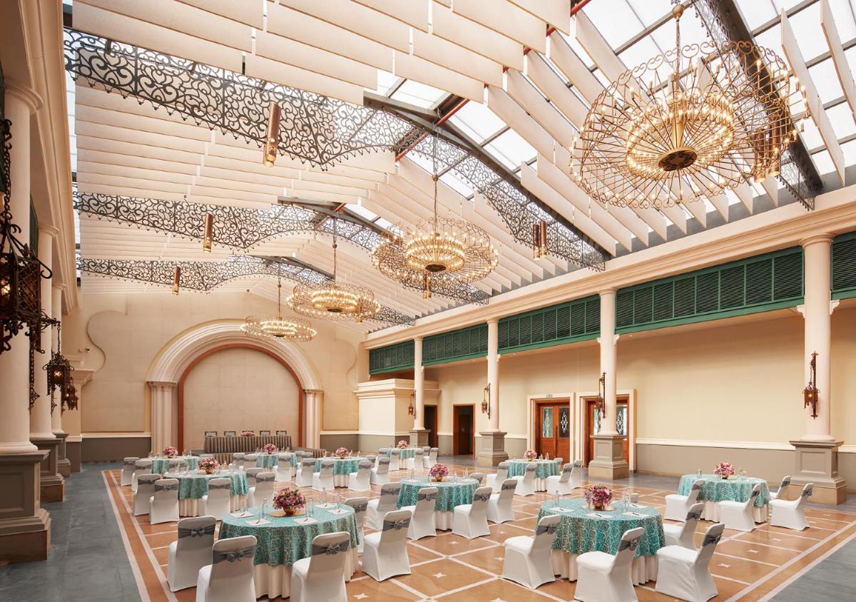 a banquet hall with tables and chairs and chandeliers at Raajkutir - IHCL SeleQtions in Kolkata