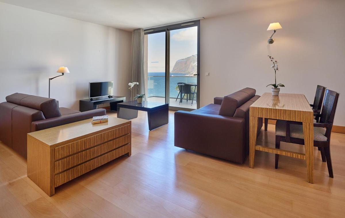 uma sala de estar com um sofá e uma mesa em Golden Residence Hotel no Funchal
