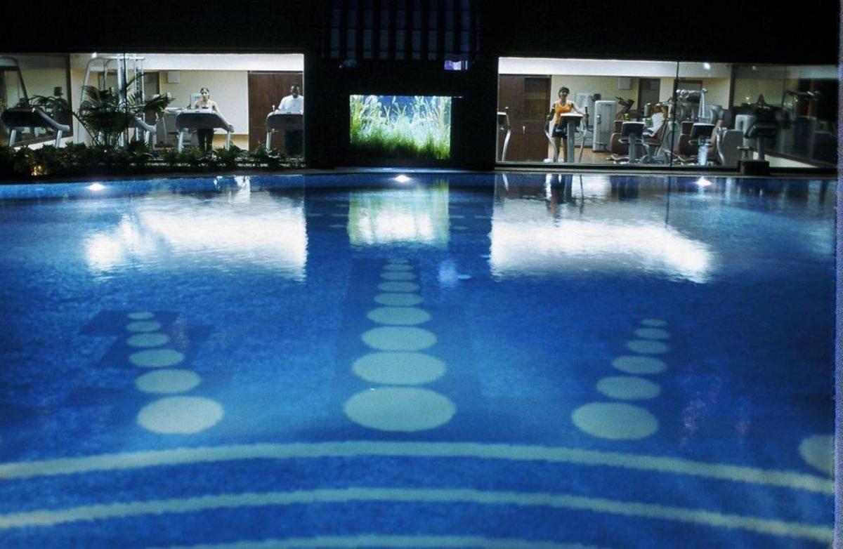 a swimming pool with a blue and white floor at The Ashok, New Delhi in New Delhi a swimming pool with a blue and white floor at The Ashok, New Delhi in New Delhi