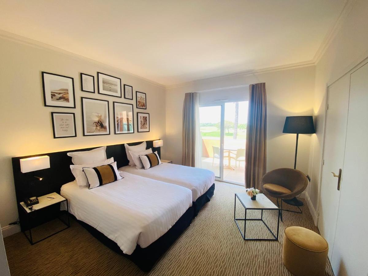 Un ou plusieurs lits dans un hébergement de l'établissement Palmyra Golf Hotel & Spa