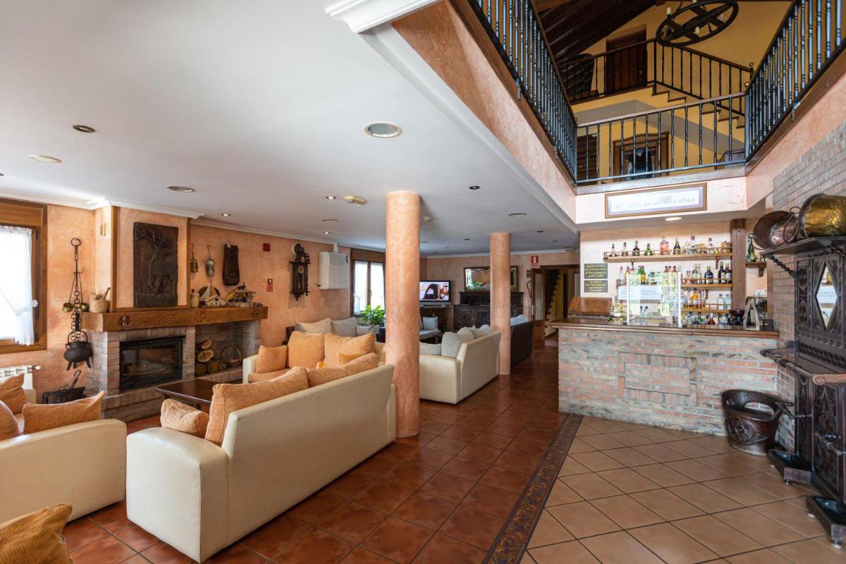 Un vestíbulo con sofás y un bar en un edificio. en Hotel & Spa Villa de Mestas, en Cangas de Onís