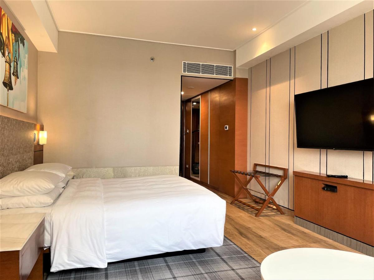 a hotel room with a bed and a flat screen tv at Hyatt Centric Janakpuri New Delhi in New Delhi
